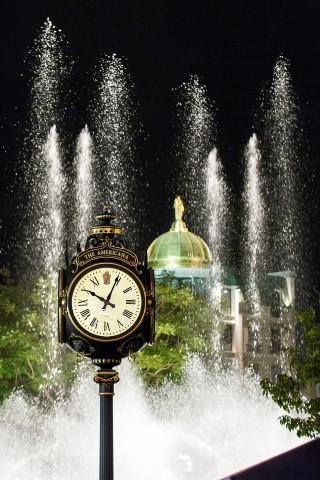 Clock with fountain behind