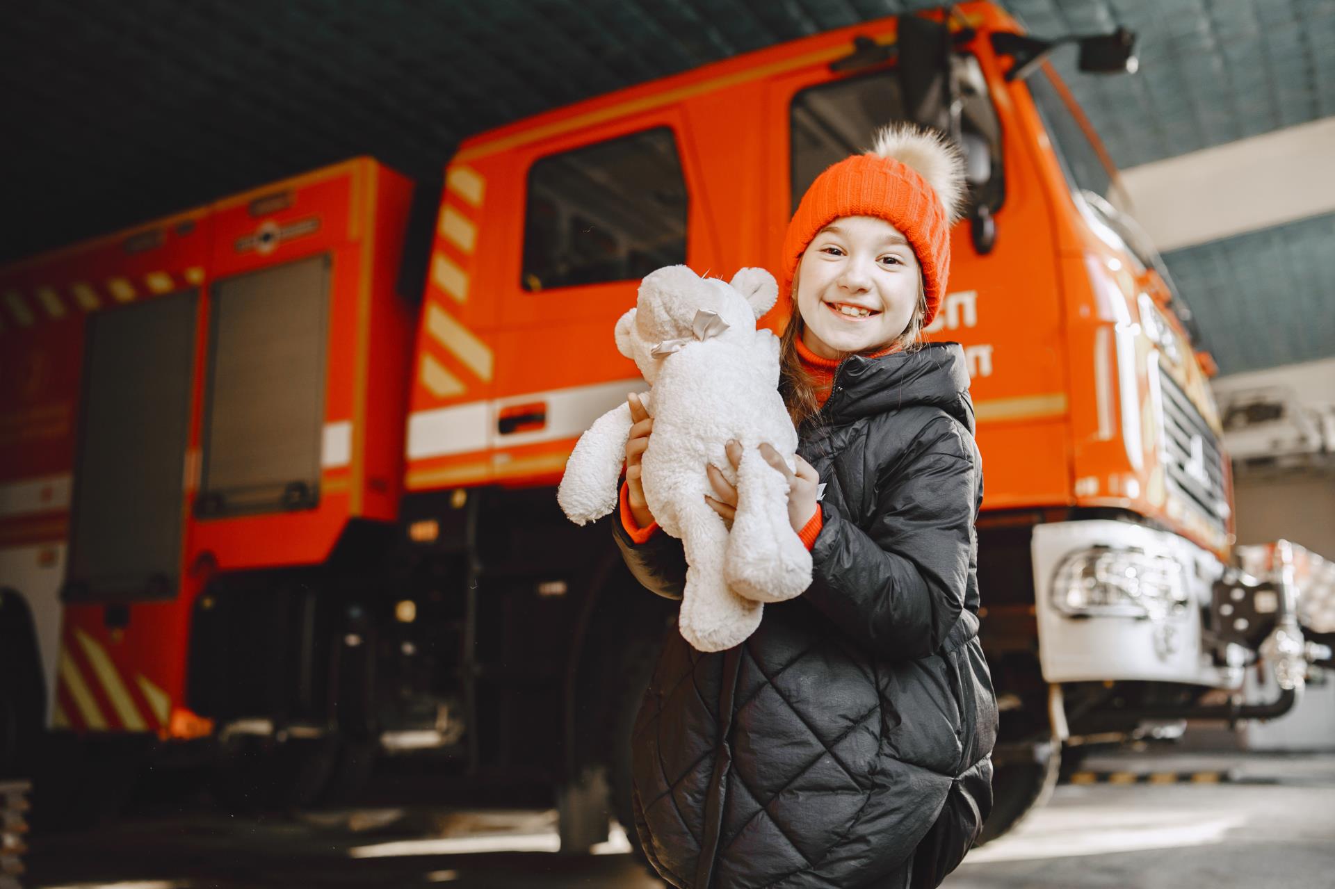 child-fire-station-girl-with-toy-child-near-fire-truck