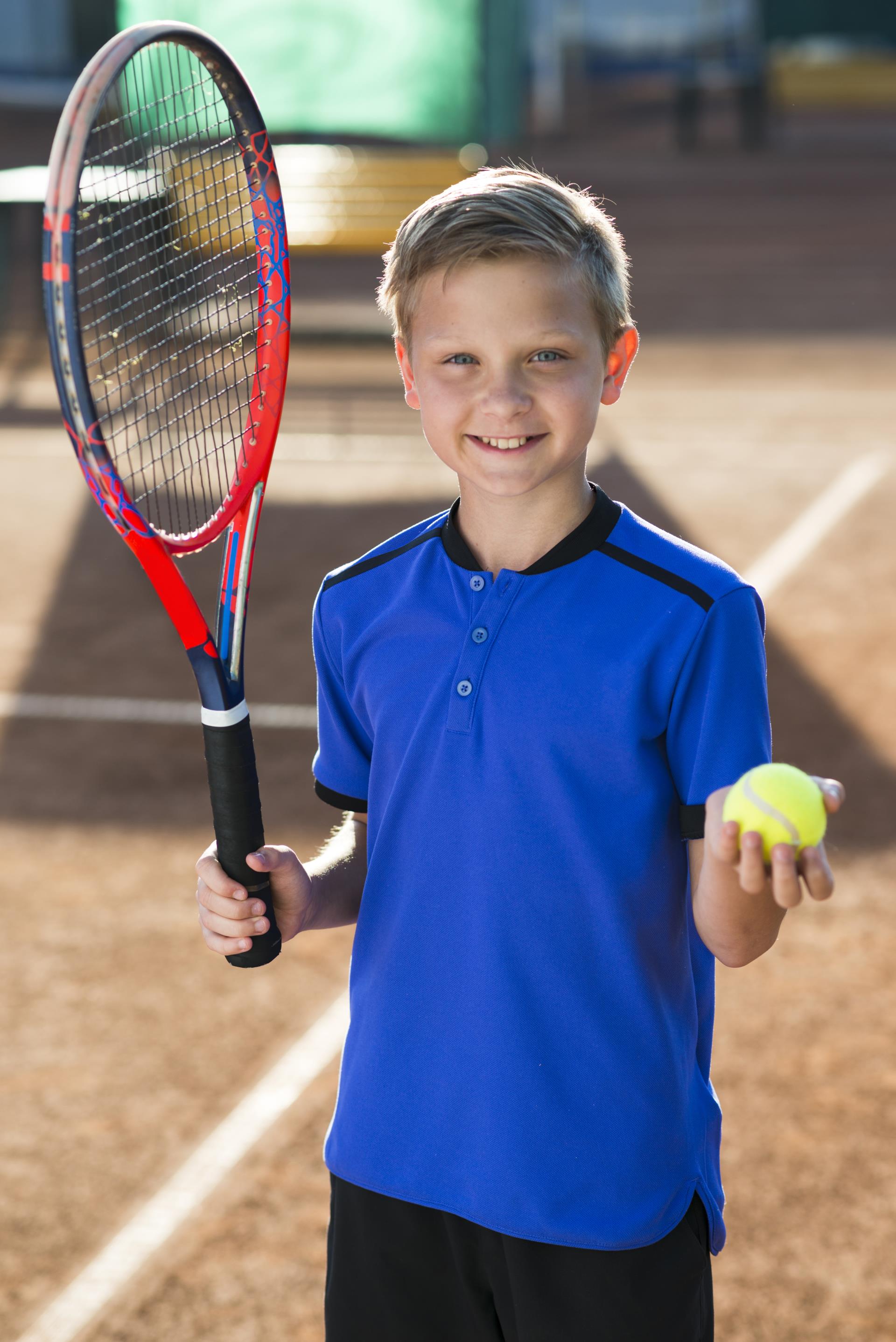 smiley-kid-holding-tennis-racket-ball