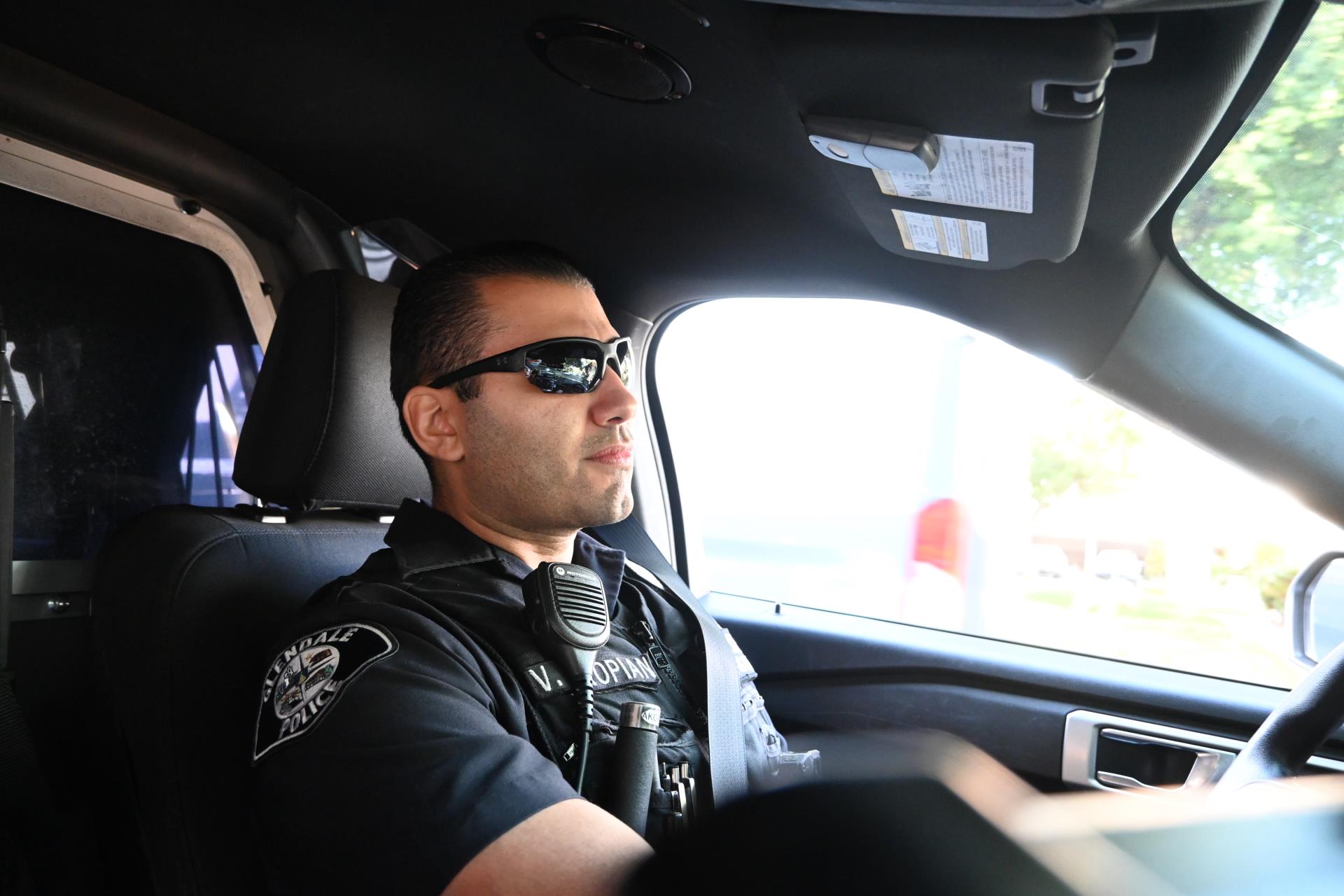 Officer Vlad Akopian driving a patrol car